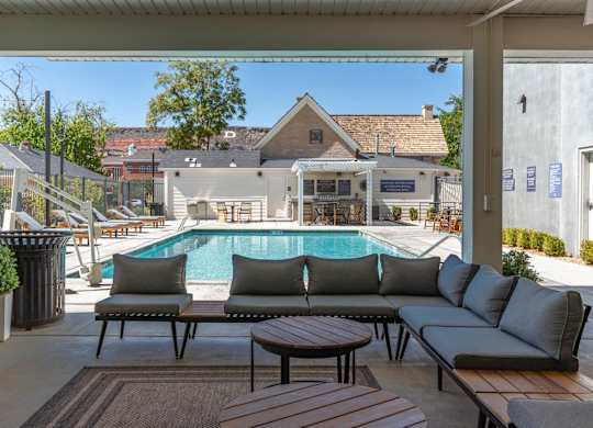 a swimming pool is seen from a patio with couches and tables at City View St. George Apartments, Utah, 84770