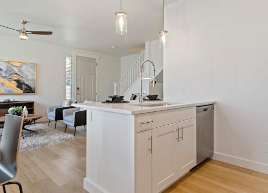 a kitchen and living room with a staircase at Alante Homes at Lake Hazel, Idaho, 83709
