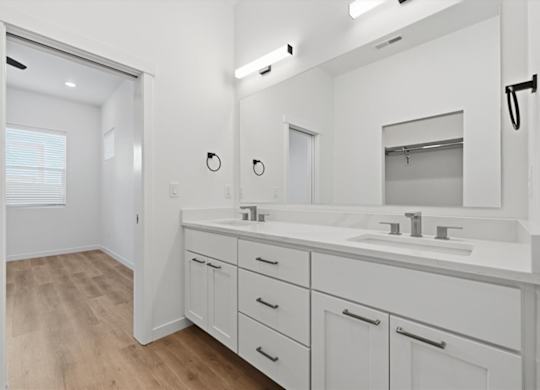 Bathroom with large mirror and 2 sinks at Alante Homes at Spring Run, Idaho, 83607