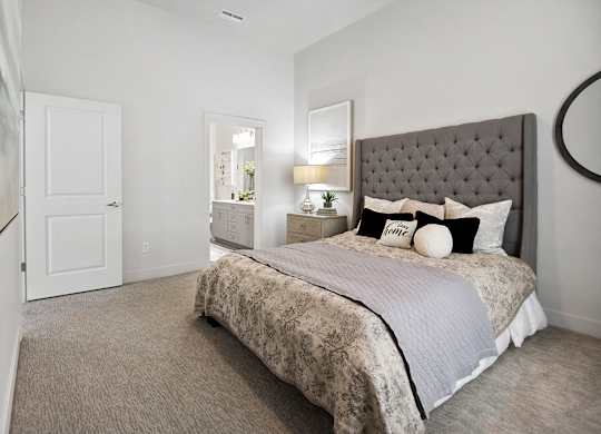 a bedroom with a bed and a door to a bathroom at 200 City View, Utah