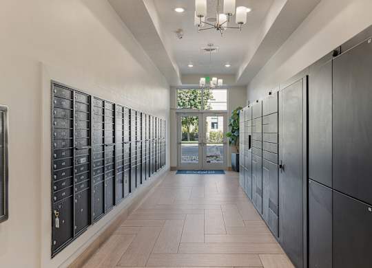 a long hallway with lockers and a door at 200 City View, Provo, UT