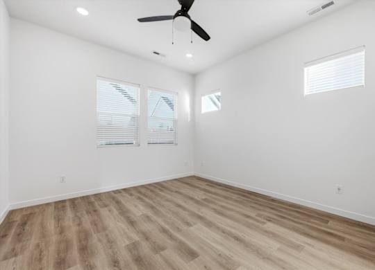 Room with wooden flooring and a ceiling fan at Alante Homes at Spring Run, Idaho