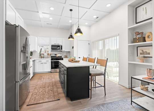 Kitchen With White Cabinetry And Black Appliances at Alante Homes at Spring Run, Caldwell, ID, 83607