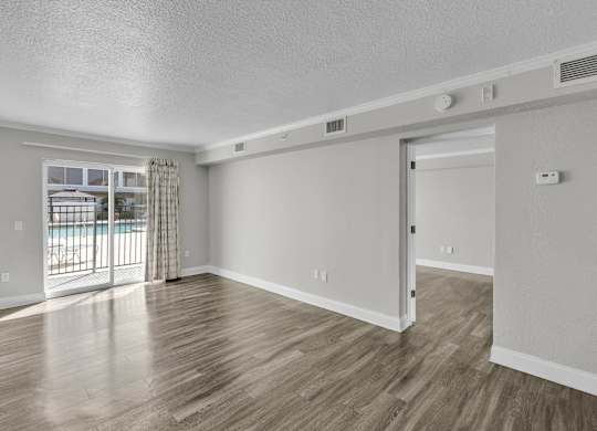 Room with sliding glass door at Avia Apartments at Reedy Creek, Kissimmee, FL