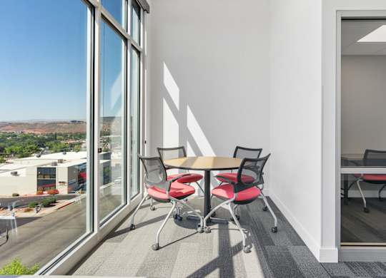 a conference room with a table and chairs and a large window at 605 Place Student Housing & Co-Living, St George, UT