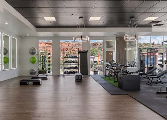 a gym with a view of a city from the window of a building at 605 Place Student Housing & Co-Living, St George, Utah
