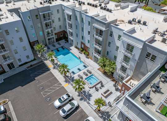 A swimming pool is surrounded by apartment buildings. 605 Place Student Housing & Co-Living, St George, UT