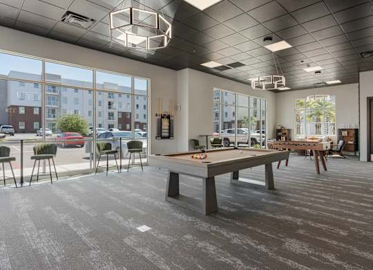 a communal area with a pool table in a tenants clubhouse at 605 Place Student Housing & Co-Living, Utah, 84770