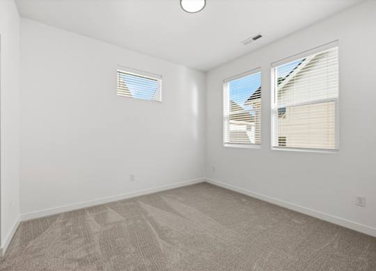 Room with multiple windows at Alante Homes at Spring Run, Caldwell, 83607