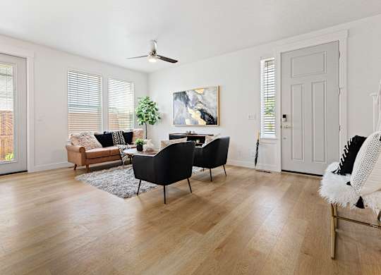 a living room with hardwood floors and white walls at Alante Homes at Lake Hazel, Idaho
