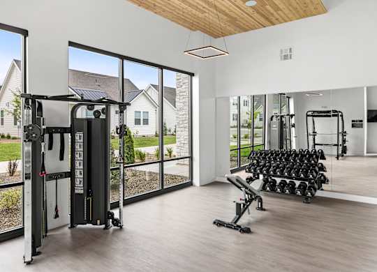 A gym with a row of dumbbells at Alante Homes at Spring Run, Idaho