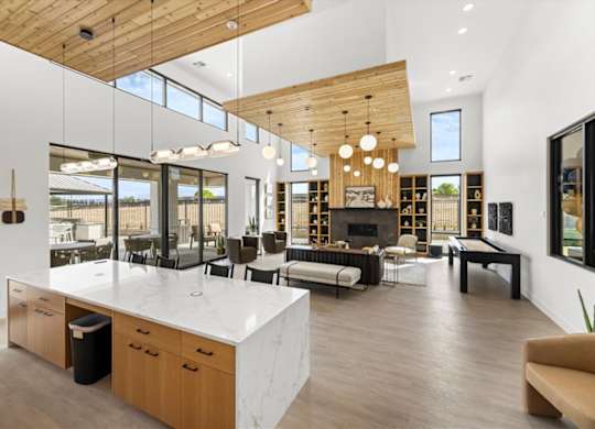 A modern kitchen with a large island and wooden ceiling. at Alante Homes at Spring Run, Caldwell, Idaho
