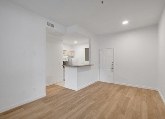 Empty room with kitchen view at AVIA Apartments On Alpha, Dallas, Texas