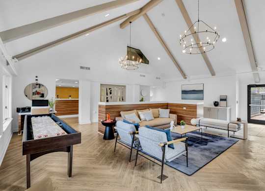 a living room with furniture and a pool table at AVIA Lofts on Liberty Ridge Apartments, Jacksonville 32256