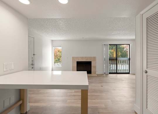 the living room and dining room of a house with a fireplace at AVIA Lofts on Parkway Apartments, Vancouver