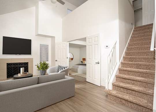 Stunning living room with a staircase at AVIA Lofts on Victors Way, Ann Arbor