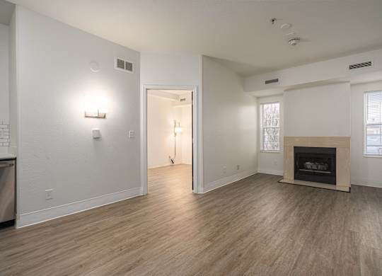 Large living room with a fireplace and wood flooring at AVIA Lofts on Victors Way, Ann Arbor, 48108