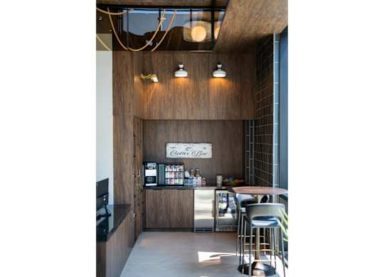 A bar area with a wooden counter and stools.