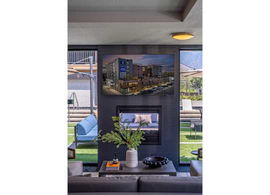A modern living room with a fireplace and a large picture on the wall.