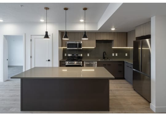 A modern kitchen with a large island in the center.