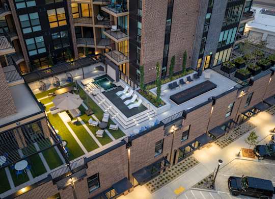 A modern building with a courtyard and a pool.