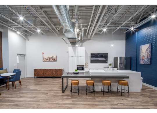 A modern kitchen with a dining table and chairs.