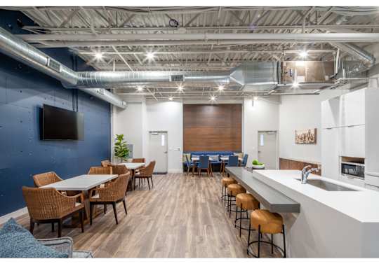 A modern kitchen with a dining table and chairs.