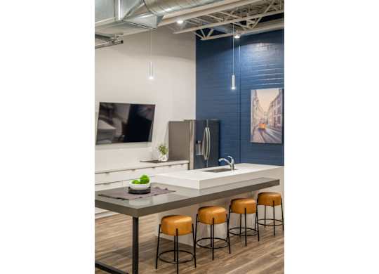 A kitchen with a table and chairs.