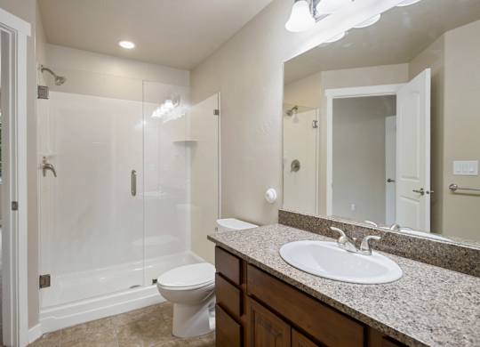 A bathroom with a toilet, sink, and shower at Siena Villas Apartments, Orem, 84097