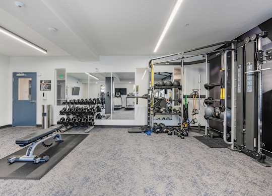 the preserve at ballantyne commons fitness room with weights and cardio equipment at The Flats at Riverwoods, Provo, Utah