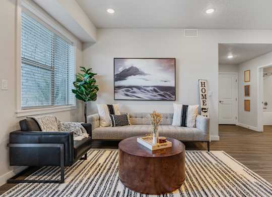 a living room with a couch and a coffee table at The Flats at Riverwoods, Provo, Utah