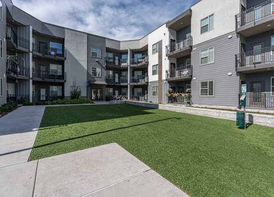 apartments patio and grass at The Flats at Riverwoods, Provo
