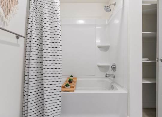 a bathroom with a bath tub and a shower curtain at Paperbox Lofts, Salt Lake City, 84101