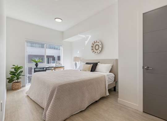 a bedroom with a bed and a window at Paperbox Lofts, Salt Lake City