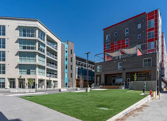 A modern building with a green lawn in front.