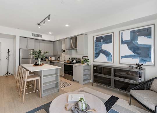 a living room with a kitchen and a dining table at Paperbox Lofts, Utah, 84101