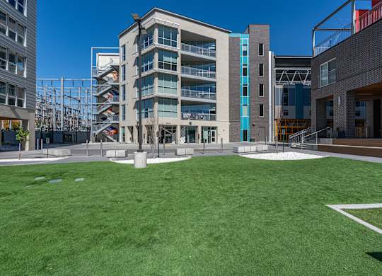 A modern building with a green lawn in front.