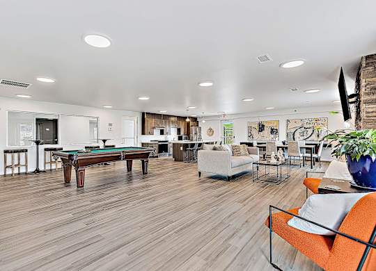 A living room with a pool table and a couch. at Red Rock Apartments, Rapid City, SD