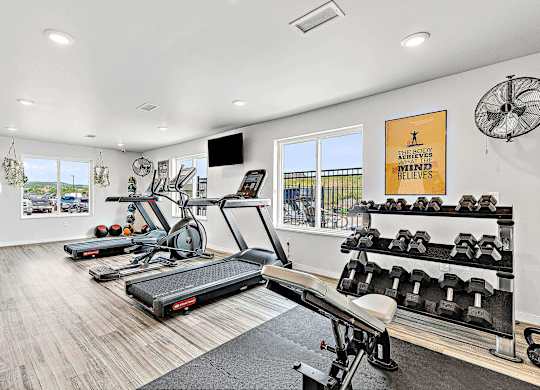 a workout room with treadmills and other exercise equipment at Red Rock Apartments, South Dakota 57702