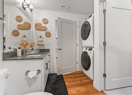 a small laundry room with a washer and dryer and a sink at The Revival, Utah, 84101