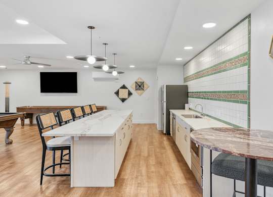 a kitchen and dining area with a marble counter top and a table with chairs at The Revival, Utah