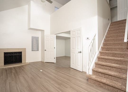 Spacious room with staircase and fireplace at AVIA Lofts on Liberty Ridge, Florida,32256