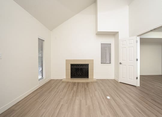 Vacant room with fireplace and wooden floor at AVIA Lofts on Liberty Ridge, Florida