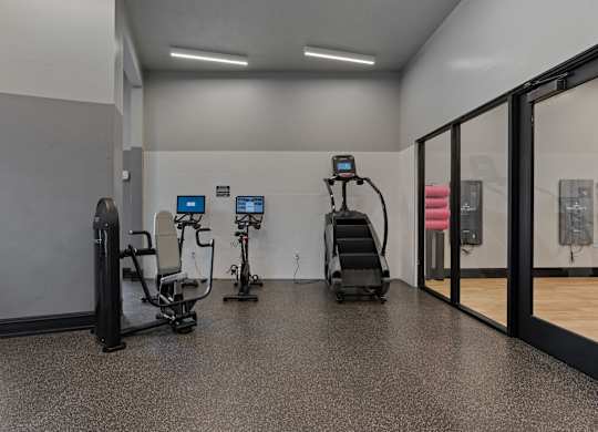 a gym with weights and cardio equipment in a building at SevenO2 Main Apartments, Salt Lake City, UT
