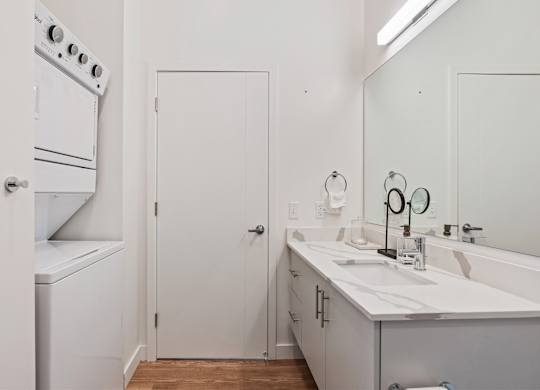 a white kitchen with a sink and a refrigerator at SevenO2 Main Apartments, Salt Lake City, Utah