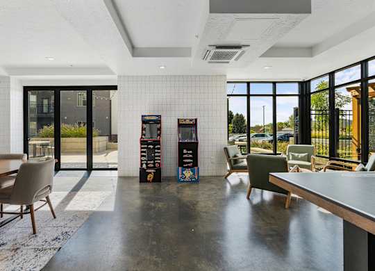 a lounge area with chairs and tables and vending machines at The Flats at Riverwoods, Provo, 84604