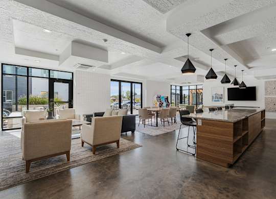 a clubhouse with a bar and chairs and a living room with a television at The Flats at Riverwoods, Provo