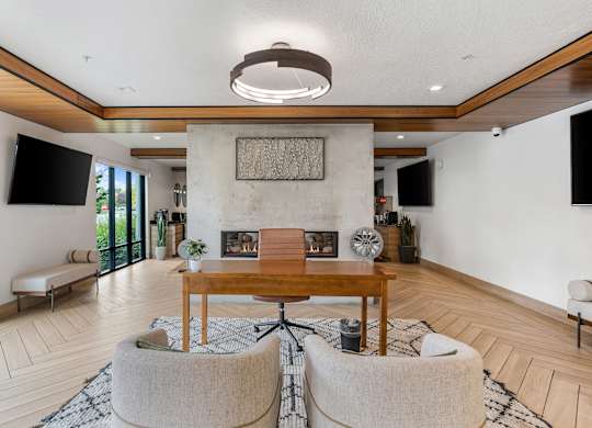 a living room with a fireplace and a table and chairs at The Flats at Riverwoods, Provo, 84604