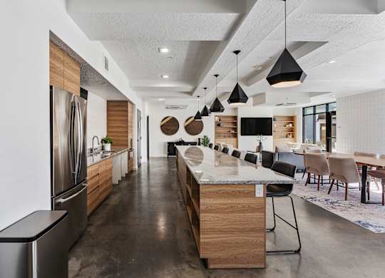 a large kitchen with a large island and a dining room at The Flats at Riverwoods, Provo, UT, 84604