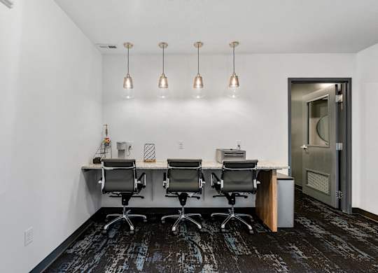 a conference room with a desk and chairs and a door at The Flats at Riverwoods, Provo, UT, 84604